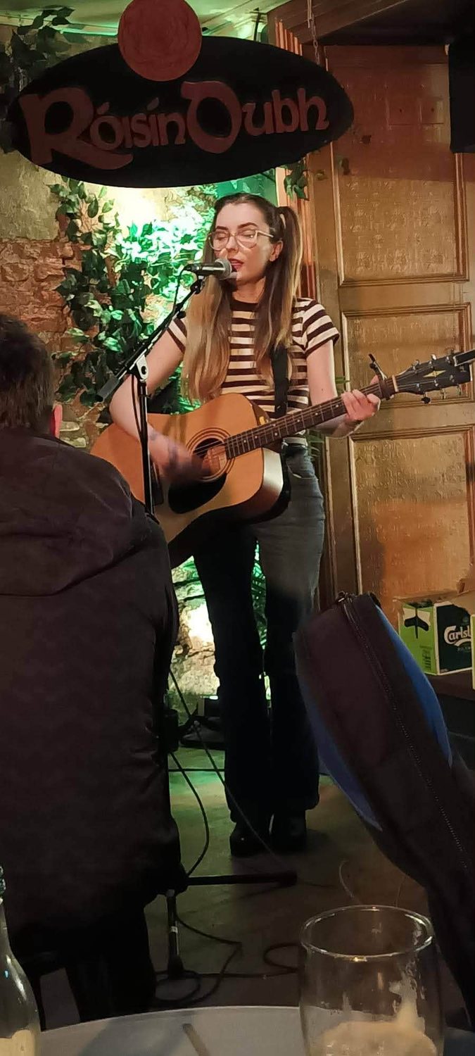 Aimée performing under the Róisín Dubh sign in Galway